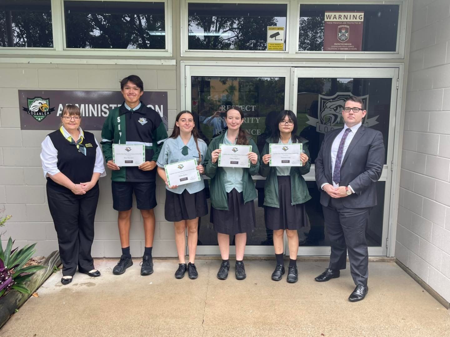 Michelle and Michael from Patinos present 4 Loganlea State High School students with scholarships.